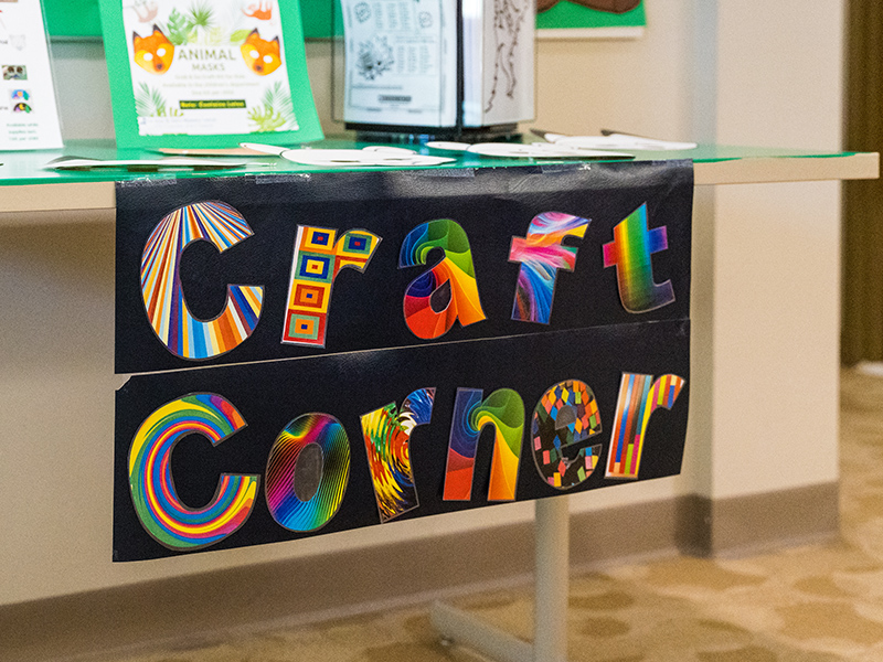 Colorful sign for Craft Corner within the library.