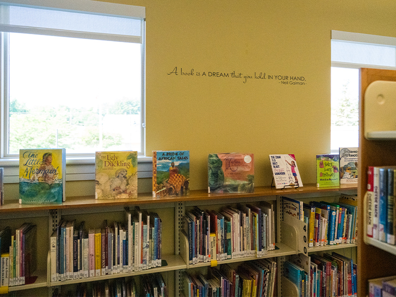 "A book is a dream that you hold in your hand" quote on wall of children's department.