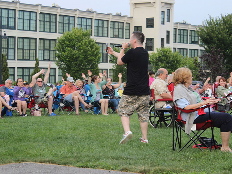 Performer at concert series concert surrounded by audience members